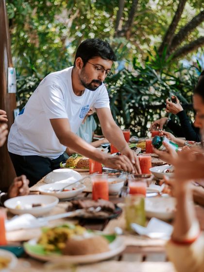 A candid shot from a community meal at Natureville. It shows the joy of sharing food and connecting with others, which is a fundamental part of the healing experience we offer.