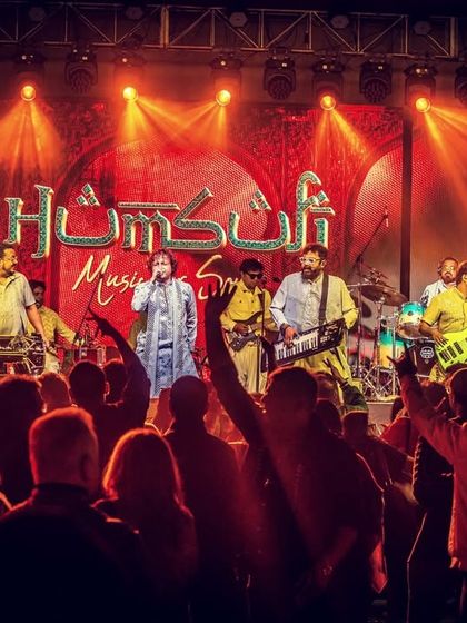 The full band on stage at DKS Club, with our name lit up behind us. This is the complete Humsufi setup, ready to deliver a night of soulful music.