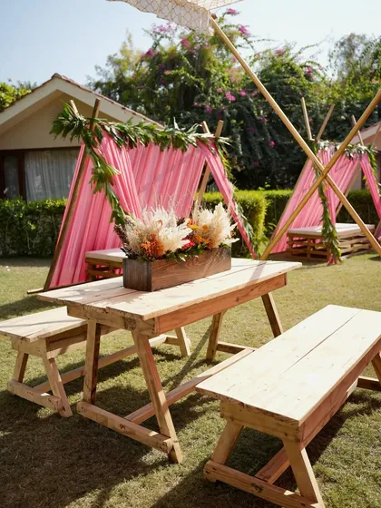 For a relaxed, boho-themed Mehendi, I designed these charming tented seating areas with rustic wooden benches. It creates a casual and intimate space for guests to chat and enjoy the festivities.