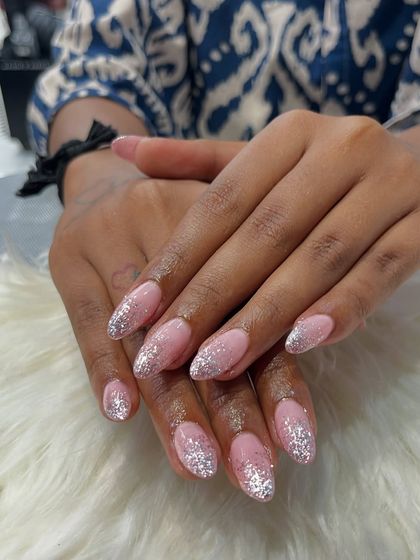 This close-up highlights the detail in the glitter work on these acrylic extensions. Each sparkle is perfectly placed to create a cascading effect that is both dazzling and sophisticated.