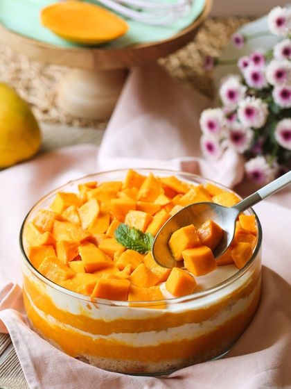 Digging into a bowl of my refreshing Mango Cream Cheese Trifle. It's the perfect way to cool down on a warm day.