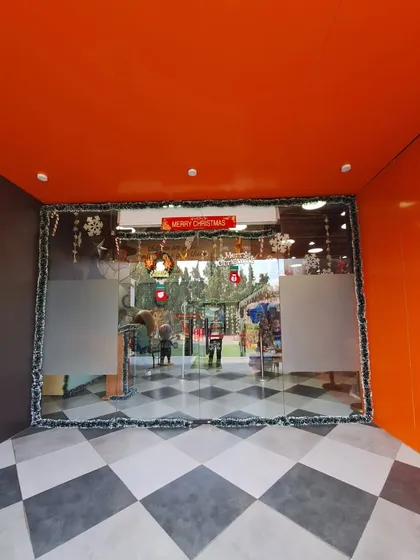 The view as you step inside Wobble World during Christmas time. The festive decorations on the glass doors set a cheerful and welcoming tone.