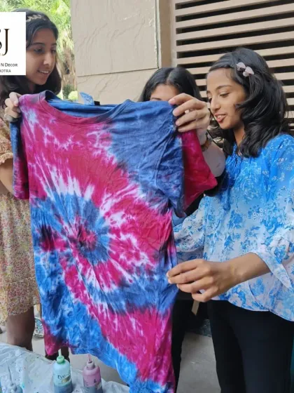 Young artists admiring their tie-dye creation. Our workshops are guided by professionals to ensure everyone has fun and gets a great result.