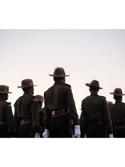 A view from behind the soldiers, showing their disciplined formation and uniforms.