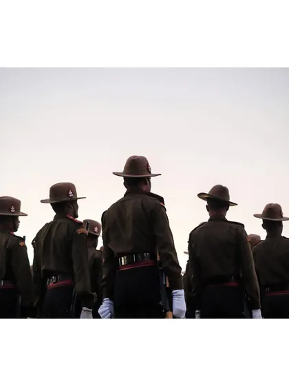A view from behind the soldiers, showing their disciplined formation and uniforms.