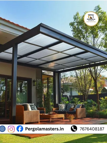 A beautiful glass-roofed pergola provides a sheltered outdoor living area surrounded by lush greenery. The transparent roof protects from rain while allowing sunlight to filter through, creating a bright and airy garden retreat.