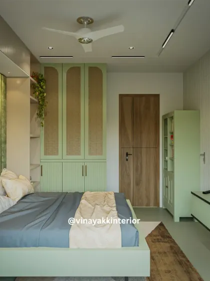 This angle showcases the room's layout, including the matching green wardrobe and TV unit. I ensure that all elements in a room are cohesive, creating a unified design story through color, material, and form.