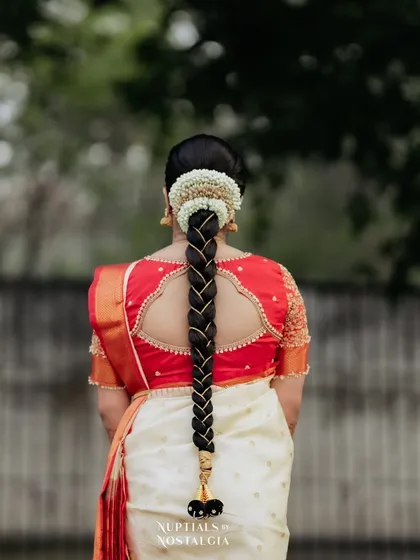 The back of the bridal look is just as important. Here you can see the classic South Indian braid, neatly done and adorned with fresh flowers.