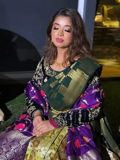 A peaceful, meditative pose showing the full outfit and the soft, glowing makeup in a different light.