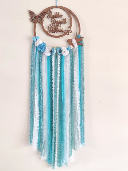 "Embrace transformation as gracefully as a butterfly." This custom name dreamcatcher features delicate butterfly and bird details, making it a whimsical piece for a nursery or child's room.