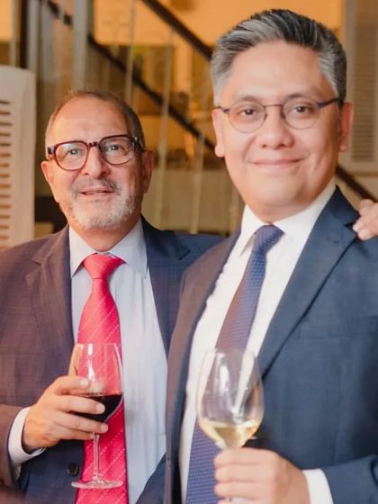 Two guests enjoying a glass of wine and conversation. Our venue is designed to foster connection.