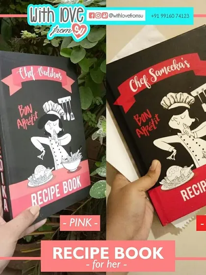 Comparing the red and pink accent color choices for the 'for her' personalized recipe book. I can customize these details to match the recipient's favorite color.