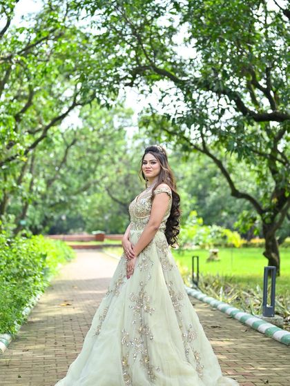 A graceful pose in the pastel green gown, demonstrating its elegant drape and silhouette.