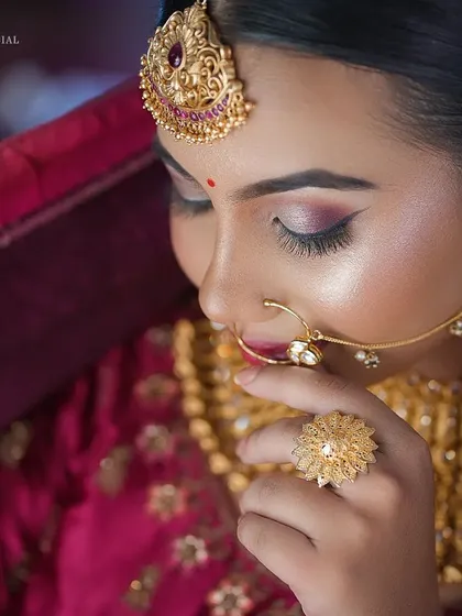 A detailed shot of the eye makeup and traditional nose ring.