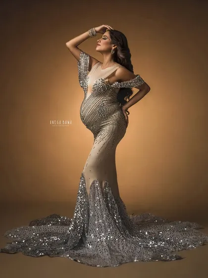 Pure glamour. This portrait showcases a stunning sequined mermaid gown against a warm, moody backdrop, creating a look of absolute luxury and confidence.