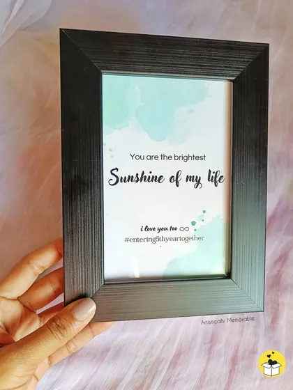 This simple black frame holds a watercolor-style print with the romantic quote, "You are the brightest Sunshine of my life," making it a sweet and minimal gift.