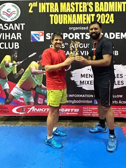 A semi-finalist from the Men's Doubles event receiving his trophy.