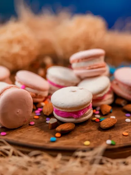 A dreamy pile of our freshly baked macarons. These delicate French cookies have a crisp shell and a chewy interior, filled with a variety of delicious ganaches and buttercreams.
