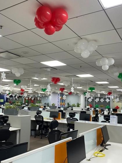 Another view of the Christmas office decorations, showing how the red, green, and white balloon clusters add festive cheer throughout the workspace.