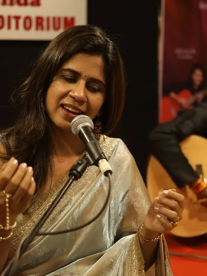 The singer and guitarist sharing a musical moment on stage. The combination of soulful vocals and acoustic guitar created a rich, layered sound that filled the auditorium.