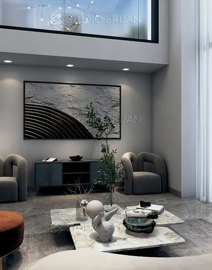 A double-height seating area in the Pitampura lobby, designed to feel open and airy. The large window and minimalist furniture create a sense of calm and space.