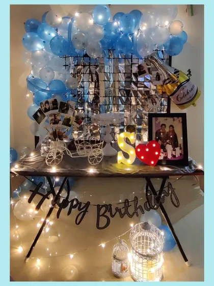 A full view of our in-house birthday decor. We can transform any corner of your home with balloons, a shimmering backdrop, fairy lights, and props like our decorative cart for displaying photos or desserts.