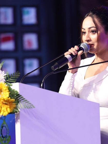 Hosting from a podium at a formal event. I can switch from an interactive party host to a formal master of ceremonies as required by the event.