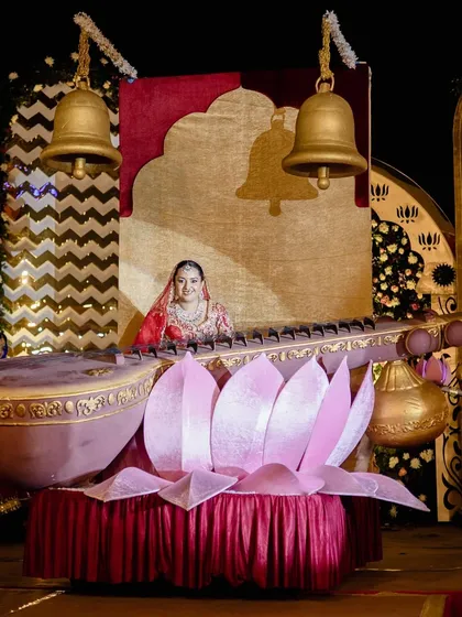 The bride makes a grand entrance seated in a giant, ornate lotus, part of a Radha-Krishna themed sangeet and varmala ceremony. We specialize in creating these unique, thematic, and memorable entries.