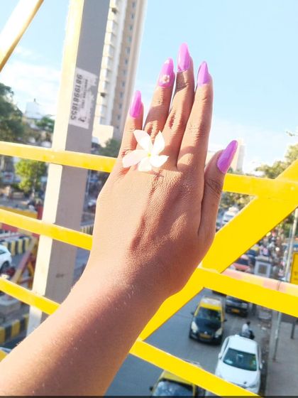 Long, stiletto-shaped gel extensions in a bright, Barbie-pink color. This is a daring and fashionable look for anyone who loves to stand out.