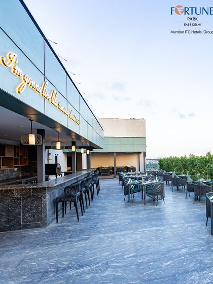 The open-air bar and seating area at Nakshatra, ready to welcome guests for an evening of fine food, drinks, and panoramic city views.