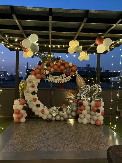 A 22nd birthday party setup under the stars. The circular balloon arch and fairy lights create a beautiful focal point for photos and celebrations.