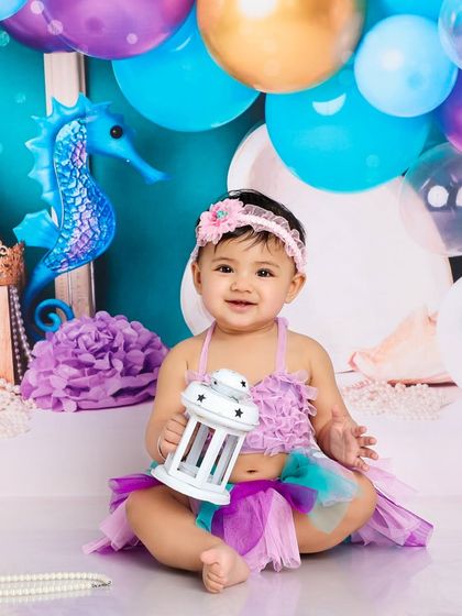 A sweet smile from our little mermaid. The soft colors and gentle lighting create a dreamy, underwater atmosphere.