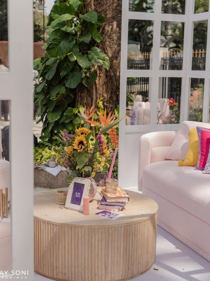 A cozy corner in the lounge, where a bright bouquet of sunflowers and birds of paradise adds a tropical flair to the decor.