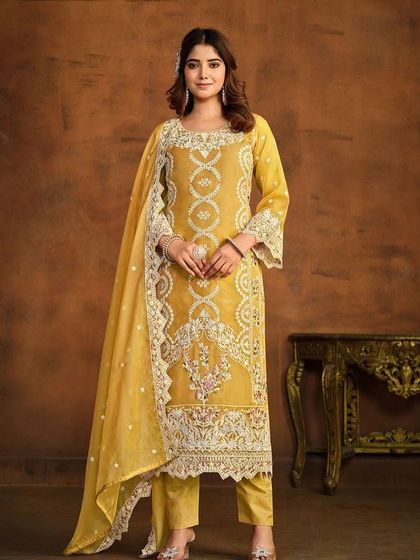 Shine bright in this yellow organza Anarkali suit. The heavy white thread embroidery and sequin work make it a perfect outfit for a Haldi ceremony or festive celebration.