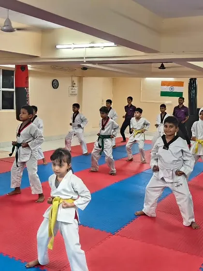 A full class of students practicing their ready stance. This image captures the focus and unity we build in our Taekwondo programs.