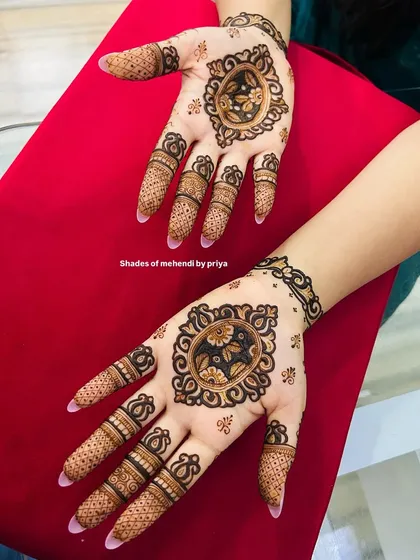 A lovely floral mandala design on the palm and a matching motif on the back of the hand. This is a great option for someone who wants a lighter mehendi look.