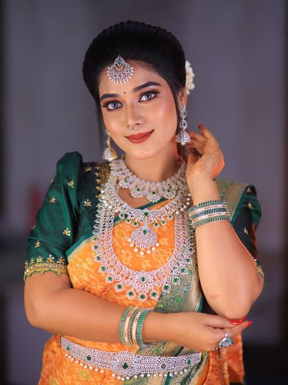 A vibrant yellow and green silk saree styled for a photoshoot. The puff-sleeve blouse adds a traditional touch, and the drape is neat and flattering.