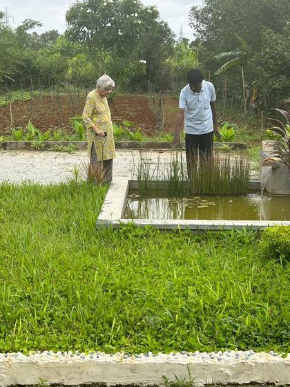 A member of our community inspects a water feature in her garden. Connecting with nature, even in a small way, is a wonderful practice for overall well-being.