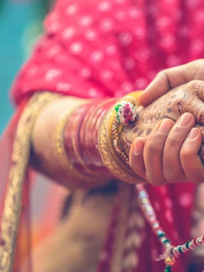 A powerful close-up of the couple holding hands during the ceremony. This image symbolizes their union and the promises they are making to each other.