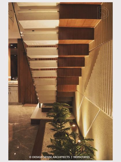 A close-up of a modern staircase design, featuring an under-stair planter and accent lighting that turns a functional element into a beautiful design feature.