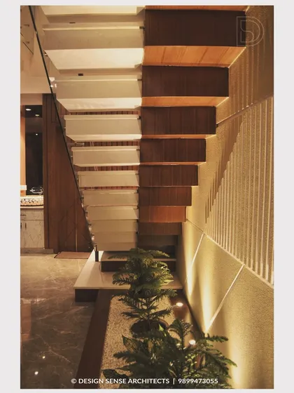 A close-up of a modern staircase design, featuring an under-stair planter and accent lighting that turns a functional element into a beautiful design feature.