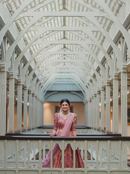 This architectural shot frames the bride beautifully, showcasing her as a work of art. Her elegant makeup and posture exude pure grace.