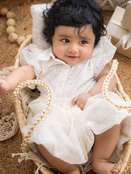 A happy smile from the baby girl during her half-birthday Boho-themed shoot.