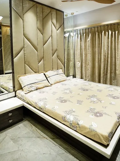 This master bedroom showcases a custom-designed headboard with geometric patterns and an integrated mirror panel. The use of Corian on the side tables adds a touch of modern elegance.