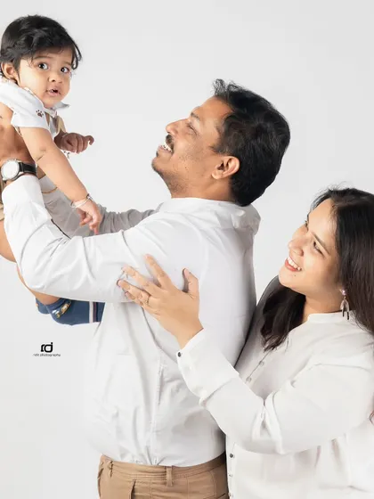 Up in the air! A father lifts his son, and the joy on everyone's faces is contagious. I love capturing these active, happy moments during a family session.