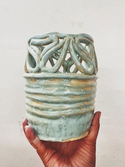 This student explored all four major techniques in her beginner's course, creating these beautiful pieces, including a delicate pierced vase and a little house luminary.