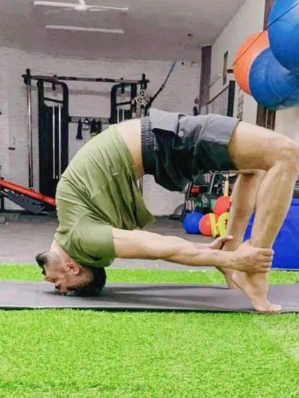 Fitness is a balance of strength and flexibility. I incorporate yoga into my training programs to improve mobility and mental peace. Here, I am performing Chakrasana, or the wheel pose, to open up the spine and shoulders.
