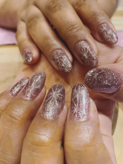 Shiny, shimmery, and perfect for the wedding season. This is a beautiful example of a rose gold cat-eye polish with a sparkling starburst design.
