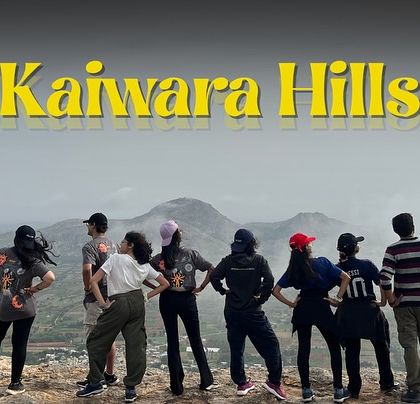 The crew posing at the Kaiwara Hills viewpoint, with the rolling hills of Karnataka in the background.