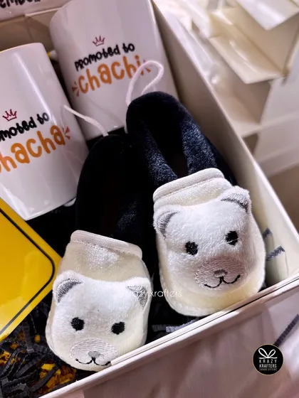 This hamper for the 'Chacha & Chachi' to-be includes adorable bear-themed baby booties and personalized mugs, making for a heartwarming pregnancy reveal.